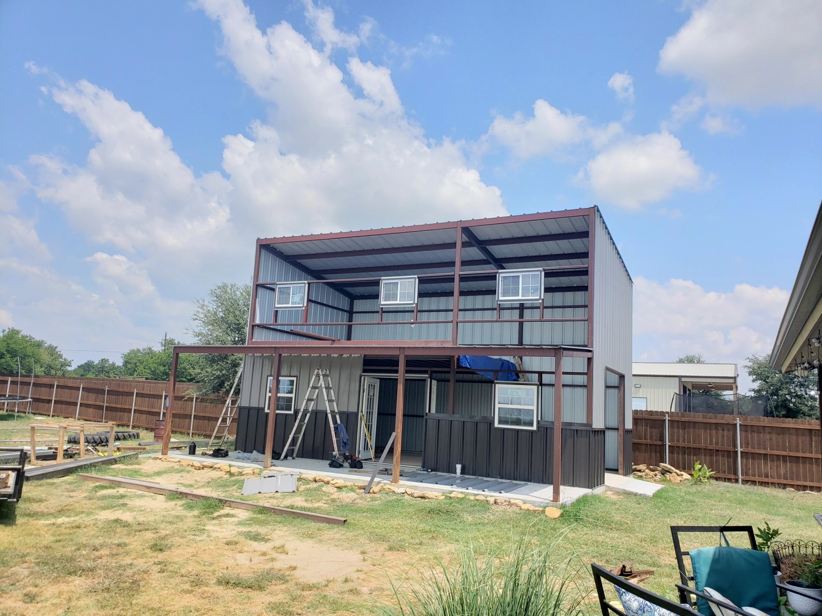 Steel-frame shop building with a loft, fully framed with metal roof, no siding yet