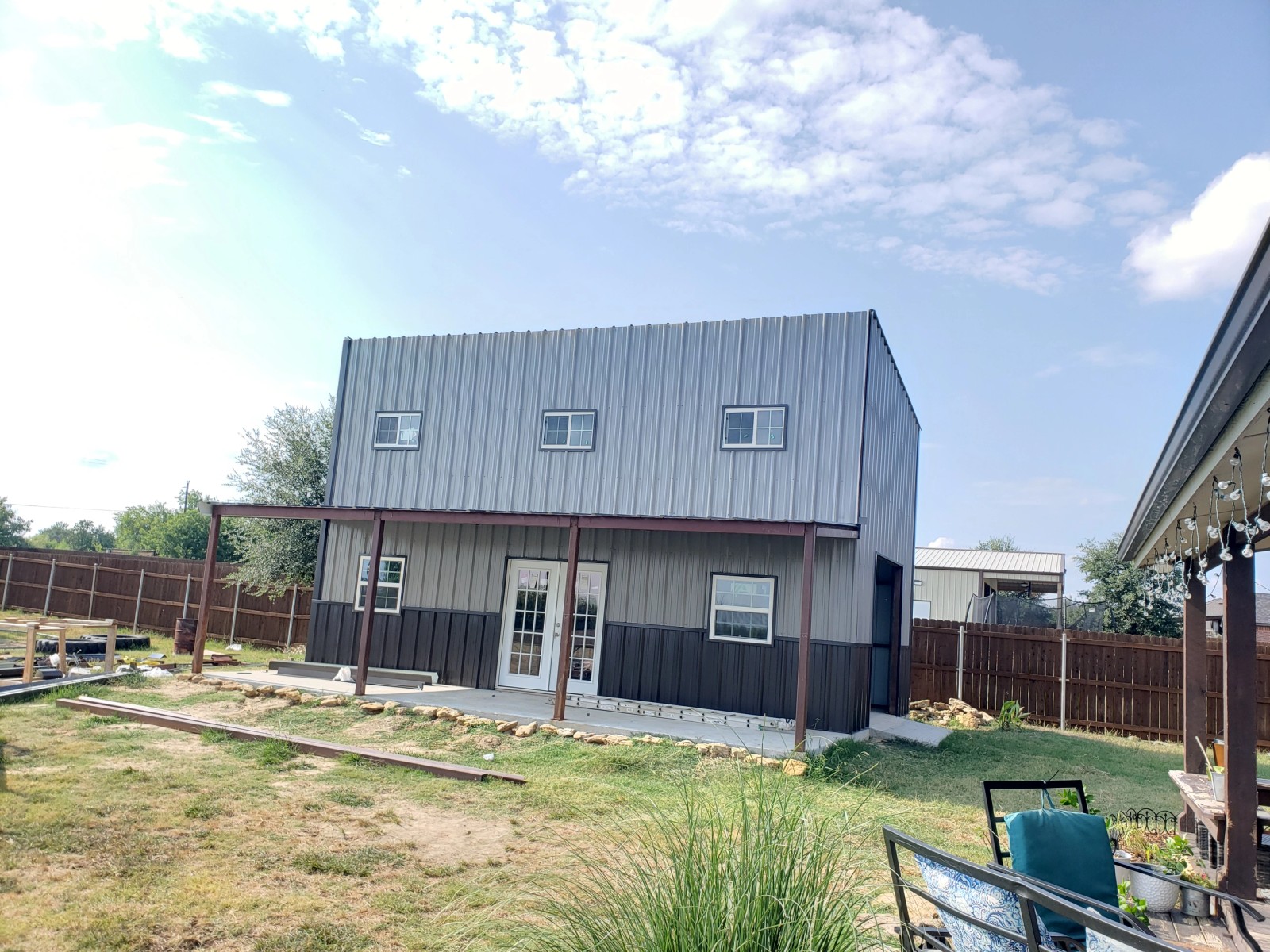 Shop building with a loft, metal siding, windows and doors installed